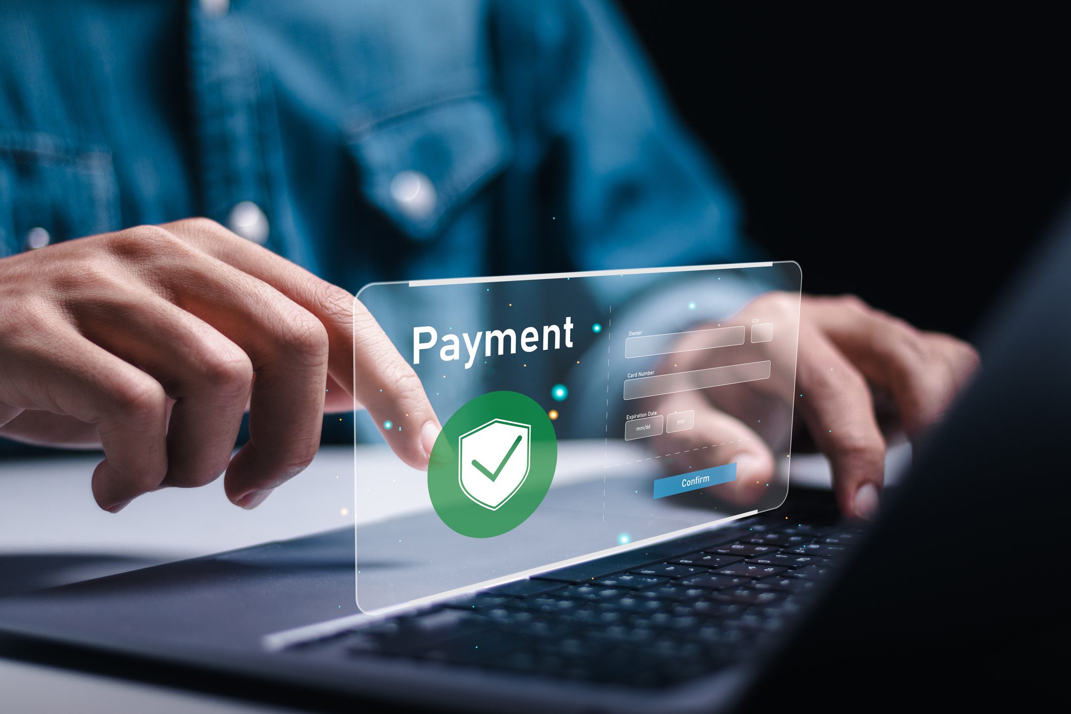 A person is typing on a laptop with the word payment written in front of them.