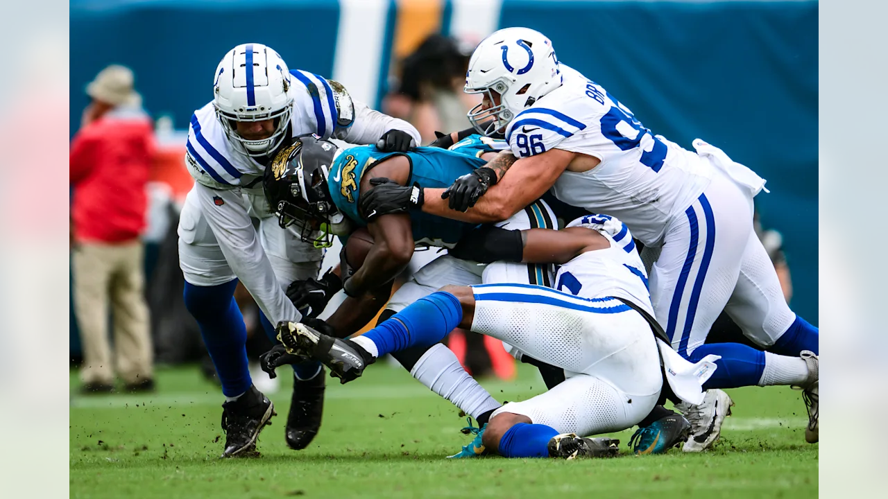 A group of football players are fighting for the ball.
