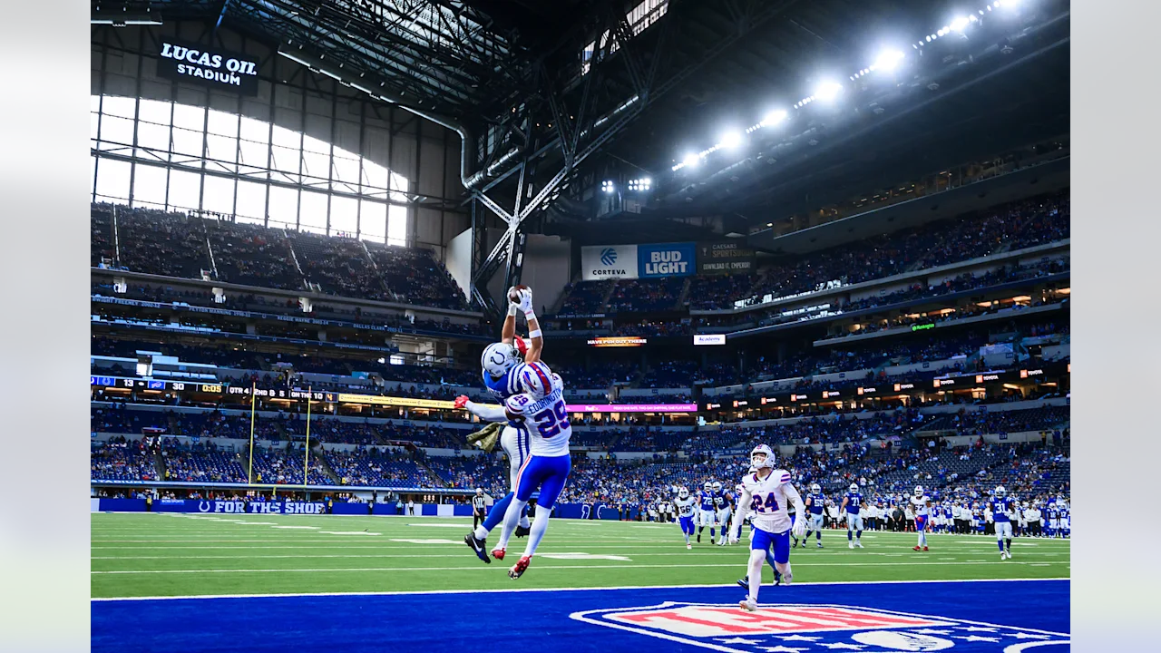 A football player jumping in the air to catch a ball.