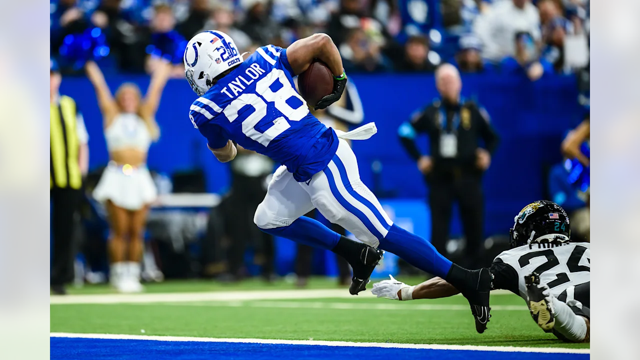 A football player running with the ball in his hand.