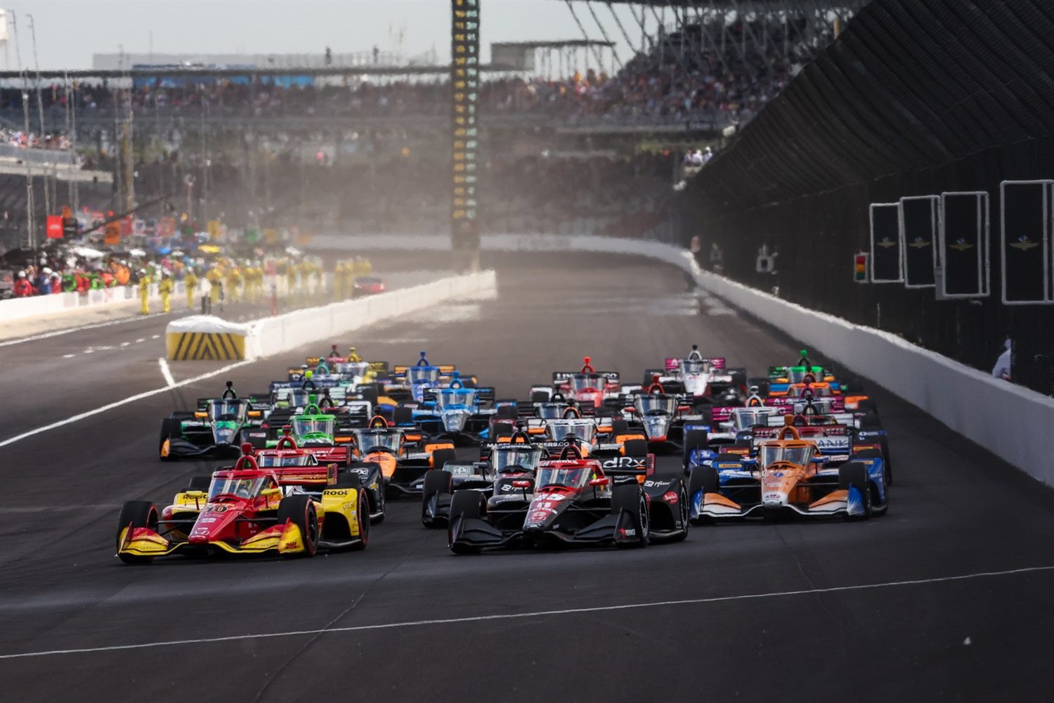 A group of cars racing on the track